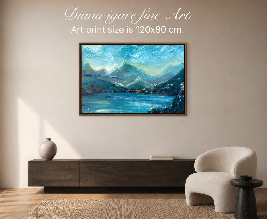 A framed landscape art print featuring blue mountains and a lake, displayed on a beige wall above a dark wood console in a modern living room setting. Text at the top reads 'Diana igare fine Art Art print size is 120x80 cm.
