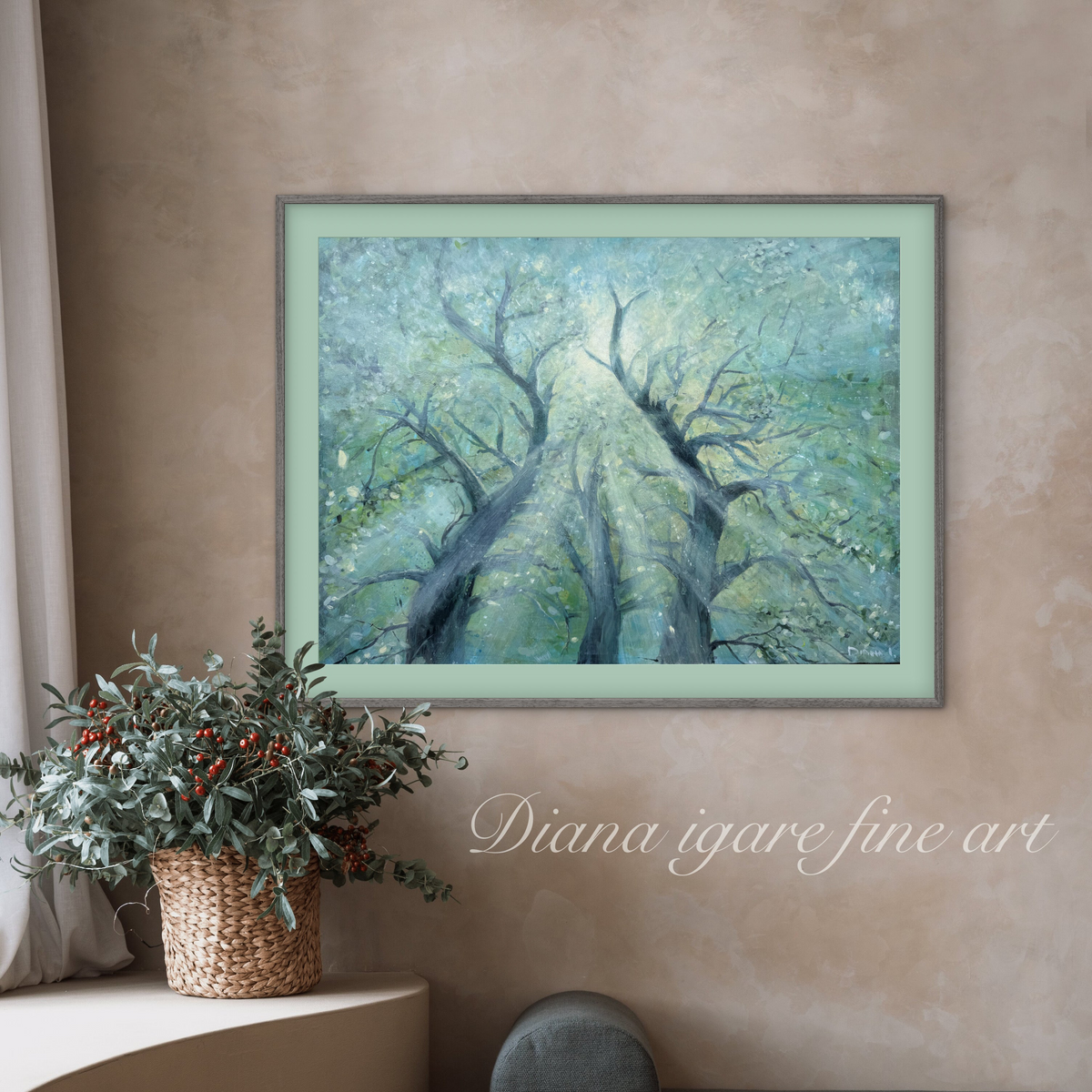 A framed art print depicting a forest of gnarled trees in shades of blue, green, and gray, displayed on a textured beige wall above a potted plant. The text 'Diana igare fine art' is written in white script on the right.
